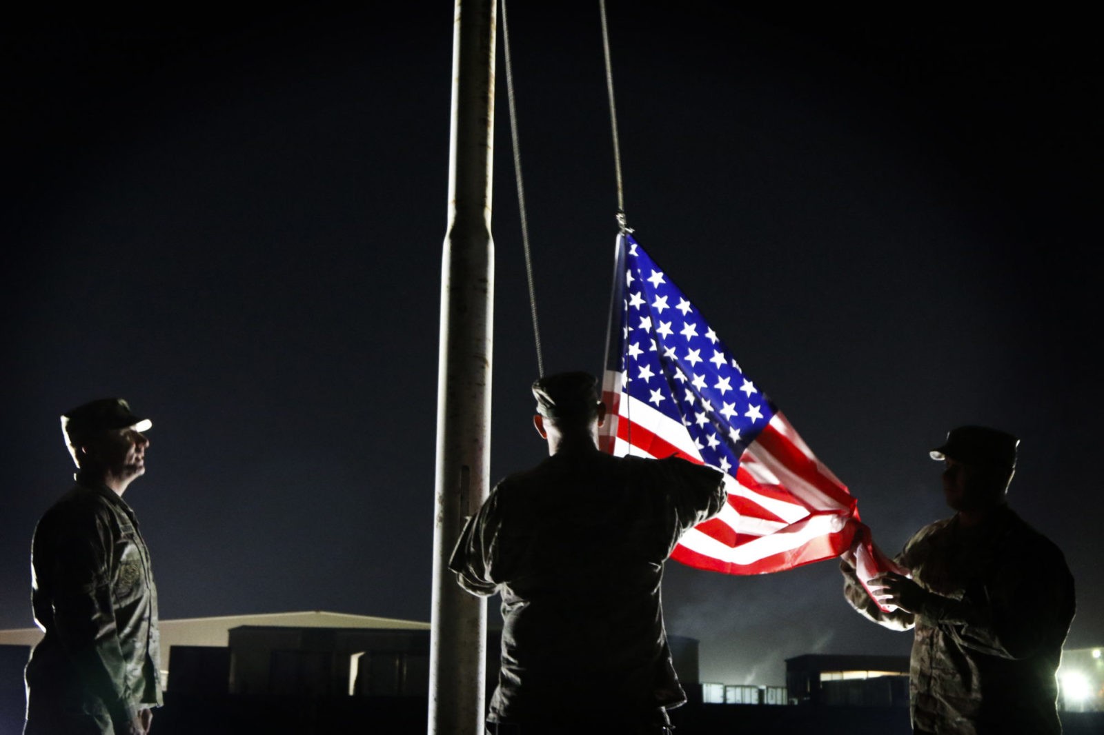 U.S. Army Reserve Soldiers, with the 316th Sustainment Command (Expeditionary), an Army Reserve unit based out of Coraopolis, Pa., and 451st ESC, an Army Reserve unit based out of Wichita, Kan., raise an American flag during an American flag honoring event at the Area Support Group – Kuwait headquarters at Camp Arifjan, Kuwait, Dec. 29, 2016. (U.S. Army Photo by Staff Sgt. Dalton Smith)