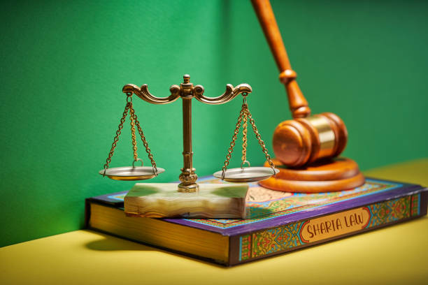 sharia law - libra scale gavel hammer and holy koran