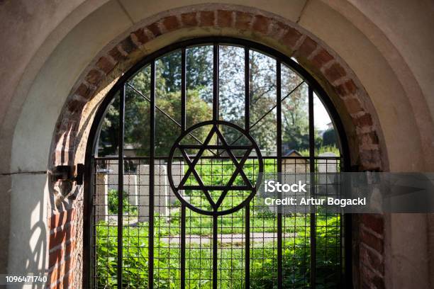 Star of David symbol on arched window grating at old cemetery in Jewish Quarter of Kazimierz in Krakow, Poland